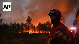 Wildfire in southwest France keeps flaring up, as firefighters try to stop it spreading across road