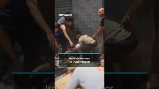Wounded Palestinians carried after Israeli strike near Al-Aqsa Martyrs hospital