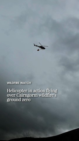 Helicopter in action flying over Cairngorm wildfire