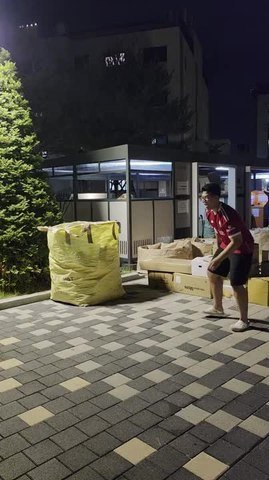 Boy Falls Onto Cardboard Boxes While Running Away With Ball