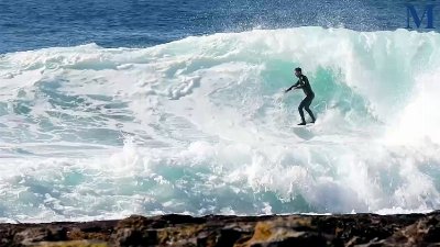 Surfers enjoy the large swell hitting the Illawarra coastline