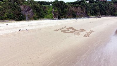 Specially created sand art installation on Tenby's North Beach marks 25 years of RNLI lifeguard service